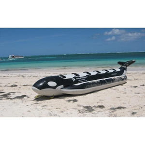 Front side view of the Island Hopper Whale Ride 6 Person Banana Boat sitting on the beach. 