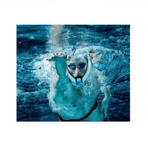 Ameo Powerbreather Wave Edition in use by a man in a swimming pool.  This is the closeup view of just the mans face and body from slightly below, coming right at the camera.