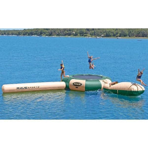 3 people playing on the Rave Aqua Jump 200 Water Park Northwoods edition.  There is a tan Aqua Log, a tan Aqua Launch, and the Rave Aqua Jump has alternating hunter green and tan panels.  The floating trampoline for lakes is in the middle of the lake.