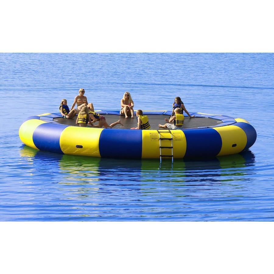 Several kids playing on a yellow and blue Rave Aqua Jump Eclipse 200 Water Trampoline out in the lake. 