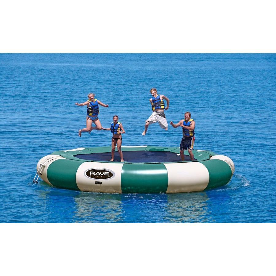 4 kids jumping on a green and tan Rave Aqua Jump Eclipse 200 Northwoods Water Trampoline