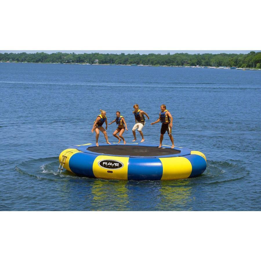 4 kids jumping on the yellow and blue Rave Aqua Jump Eclipse 200 Water Trampoline out on a lake.