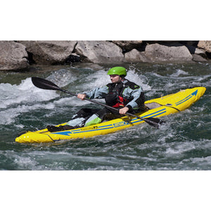 Yellow Advanced Elements Attack Whitewater 1 Person Inflatable Kayak in the water going through mild rapids. 