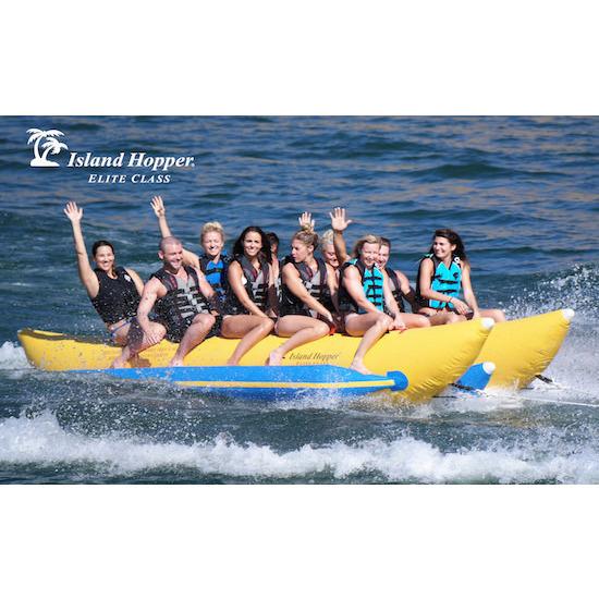 Island Hopper 10 Person Banana Boat Tube being used in the middle of the lake, splashing across the wake.  Front side view.