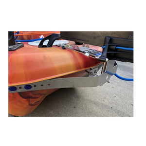 Bixpy WillFit Gudgeon attached to a red/orange kayak and universal rudder adapter. Close up view and only the back of the kayak and the concrete floor are visible.