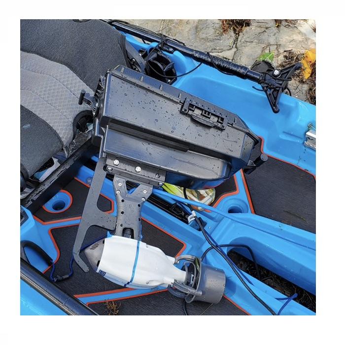 Bixpy Jet Kayak Motor for sale is shown in a blue Bonafide kayak hooked up to the Bixpy Pod Adapter for Bonafide Kayak.  The Bonafide Kayak Pod is all black and looks like a plastic center console for a car.