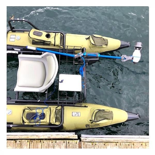 Bixpy Universal Transom Adapter is shown on a personal pontoon.  The Bixpy Transom Adapter is in the upright and locked position out of the water.