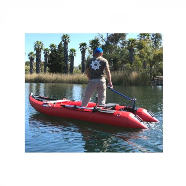 Bixpy Universal Transom Adapter is shown to be easy to use in this image of a man standing up and steering his inflatable boat with the Bixpy Transom Adapter.  View is from the side of the boat, which is in the water.