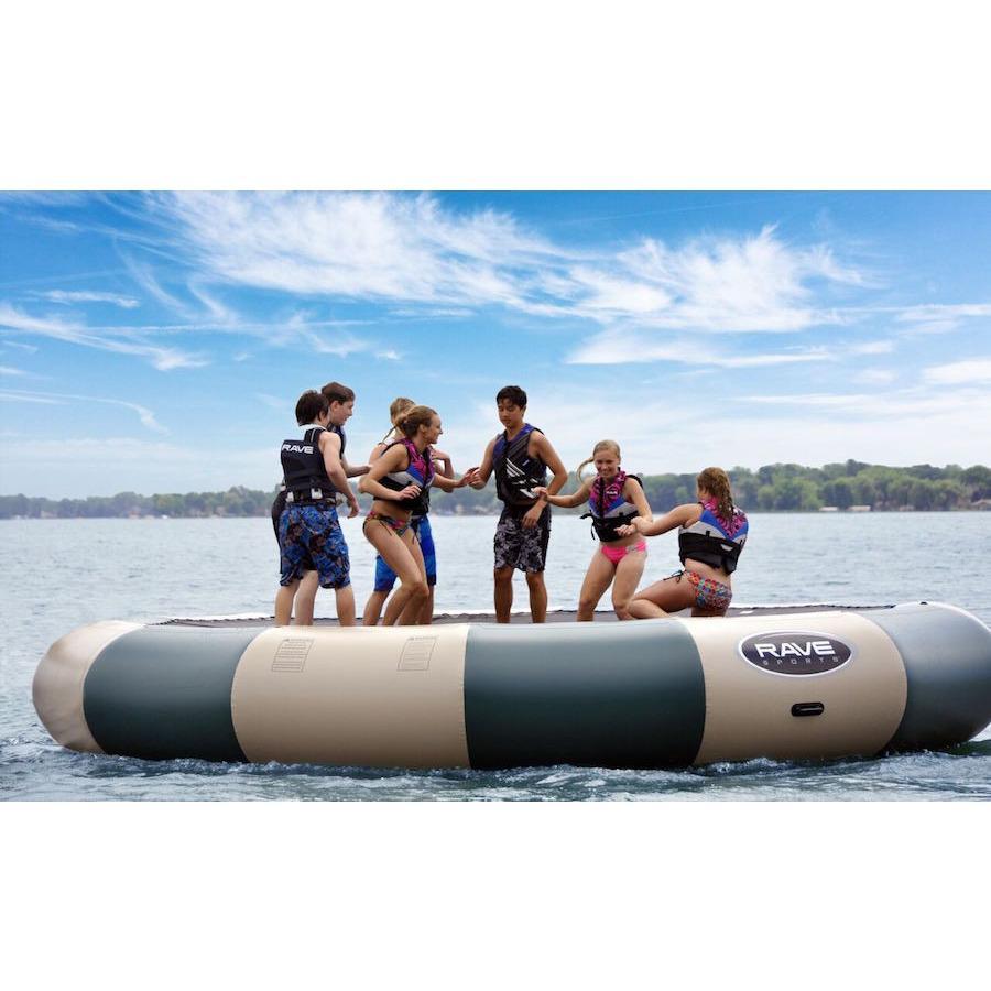 Rave Bongo 20 Northwoods Water Bouncer being bounced on by 6  kids on the lake.  Green and tan inner tube on a dark blue lake against a beautiful blue sky. 