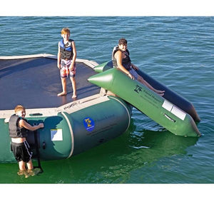 3 young boys getting ready to slide down the Island Hopper Bounce N Slide Inflatable Water Bouncer Slide. It is natural green and blends in nicely with the blue green water.