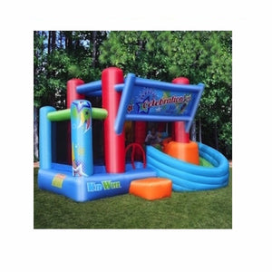 KidWise Celebration Bounce House and Tower Slide | Side view of the KidWise Bouncer outdoors in the backyard.  The KidWise Bounce house is predominantly Royal blue, light blue, and red with some green and orange accents.  KidWise Bouncer banner over the bounce house curved slide.