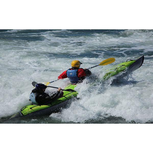 Green Advanced Elements AdvancedFrame Convertible Inflatable Kayak going through whitewater rapids.