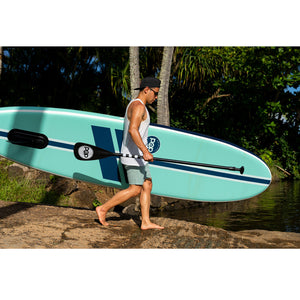 Yacht Hopper SUP Teak/Blue/Mint being carried to the water.