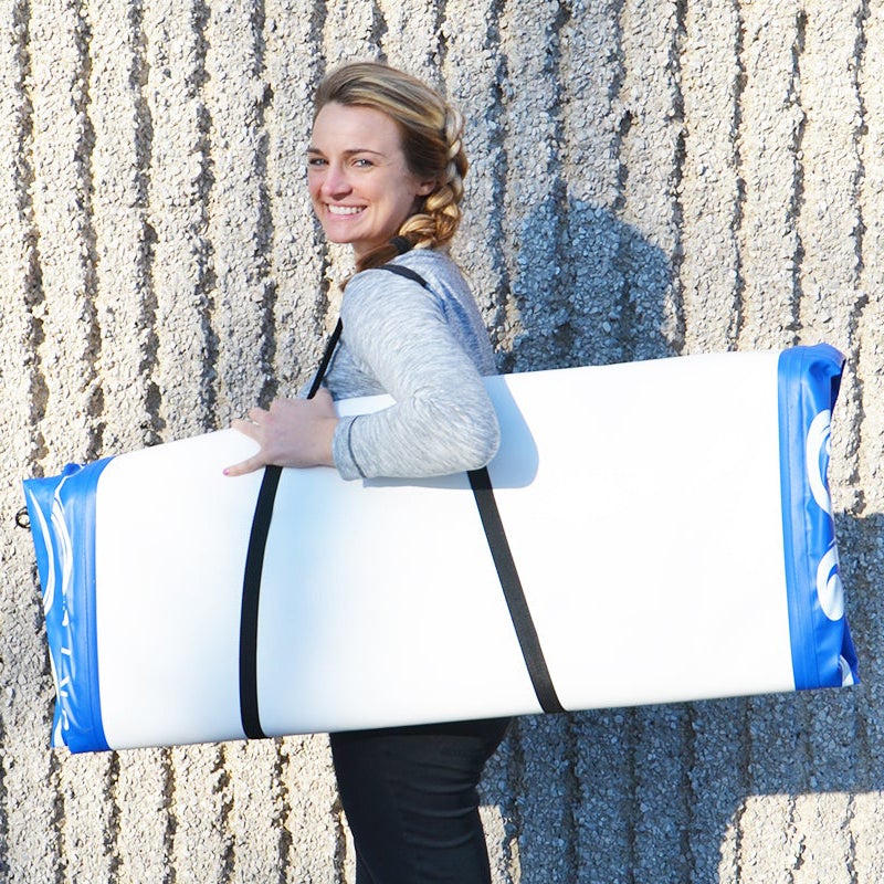 This image shows a woman carrying the folded Rave Fitness Mat on the go. It looks lightweight and easy to carry.