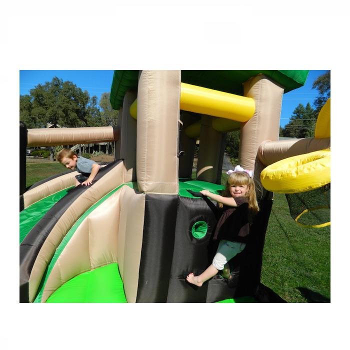 Island Hopper Fort All Sport Bounce House Climbing Wall girl climbing on the inflatable climbing wall and boy on the slide.