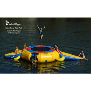 5 kids playing on the Island Hopper 15' Gator Monster Water Trampoline Water Park sitting on the lake.