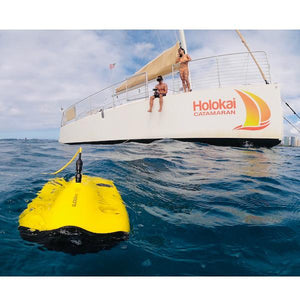 Chasing Gladius Mini Underwater Drone is on the surface of the water being controlled by a man on a boat on the ocean.  The underwater drone for sale is ready to break the surface and explore.
