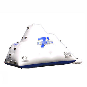 Side view of the slide side of the white Rave Floating Inflatable Iceberg 7 with blue lettering and climbing handles.  Image is on a white background. 