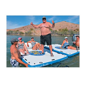 Island Hopper Island Buddy Floating Swim Platforms hooked together in a lake.  1 large man is standing on the inflatable swim dock while 2 others are laying on it.  There are also 2 people on the second Island Hopper Floating Swim Platform.