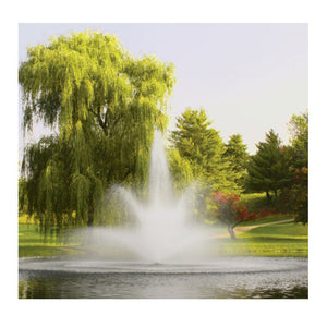 This is the 5 HP 5.3JF Floating Fountain in the middle of the pond in a park-like environment.