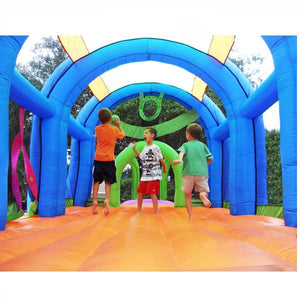 Inside of the KidWise Arc Arena 2 Inflatable Sports Bounce House showing kids playing on the orange bouncer floor surface.
