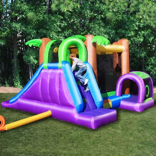 KidWise Monkey Explorer Jumper outdoors, showing the purple climbing wall and slide side of the recreational bounce house. 