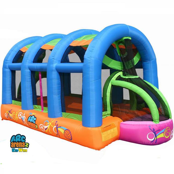 KidWise Arc Arena II Inflatable Sports Bounce House display image. The outside of the lower perimeter is orange and there are 4 inflatable blue supports that go over the top.  Soccer goal is visible with pink outer edge and lime green supports.