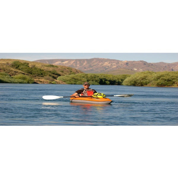 Orange Advanced Elements Lagoon 1 Solo Inflatable Kayak being paddled out on the water. 