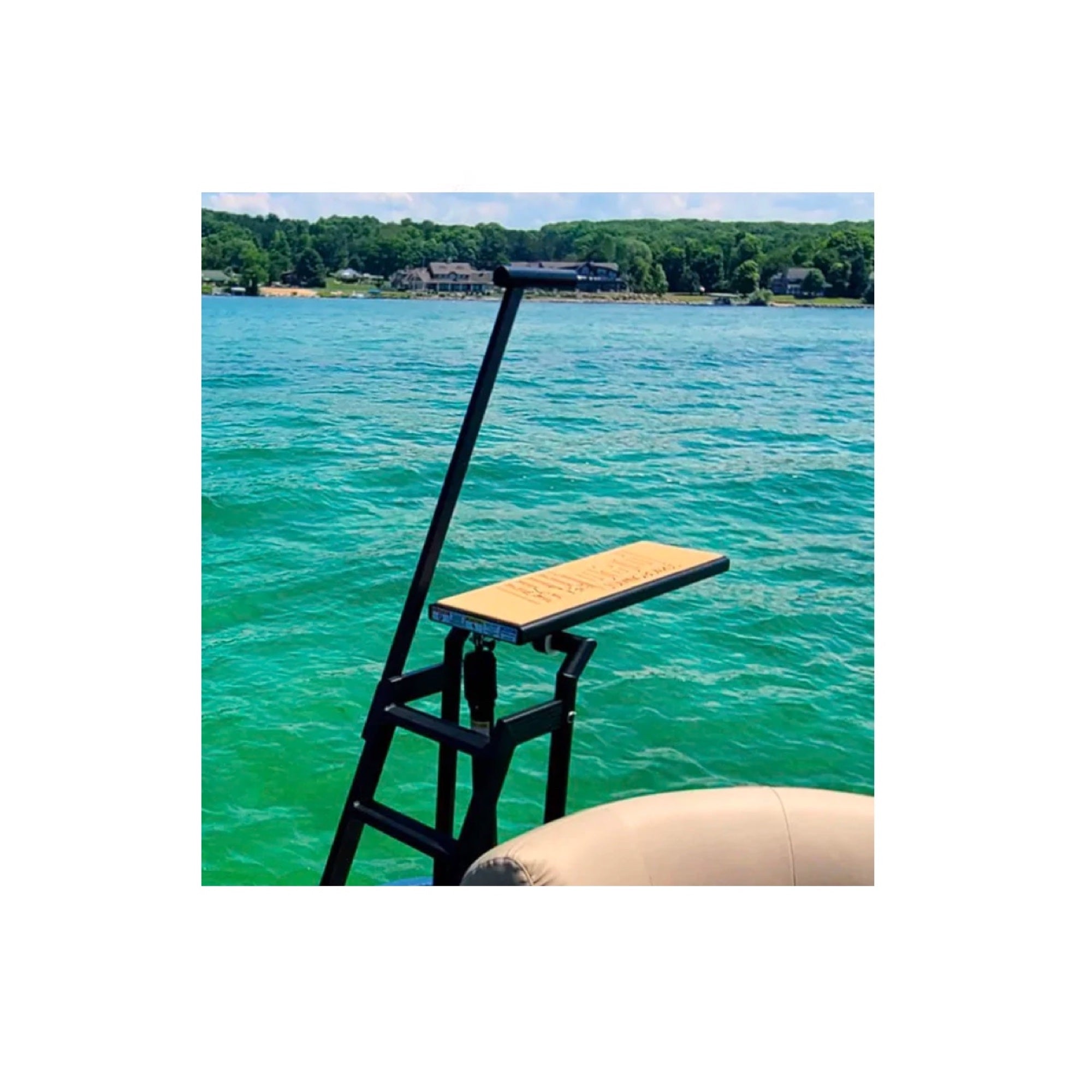 This is the Lillipad Diving Board with the Black Powder-Coated Finish of the Mocha/Black Variation rested on the edge of the boat in the middle of the sea.
