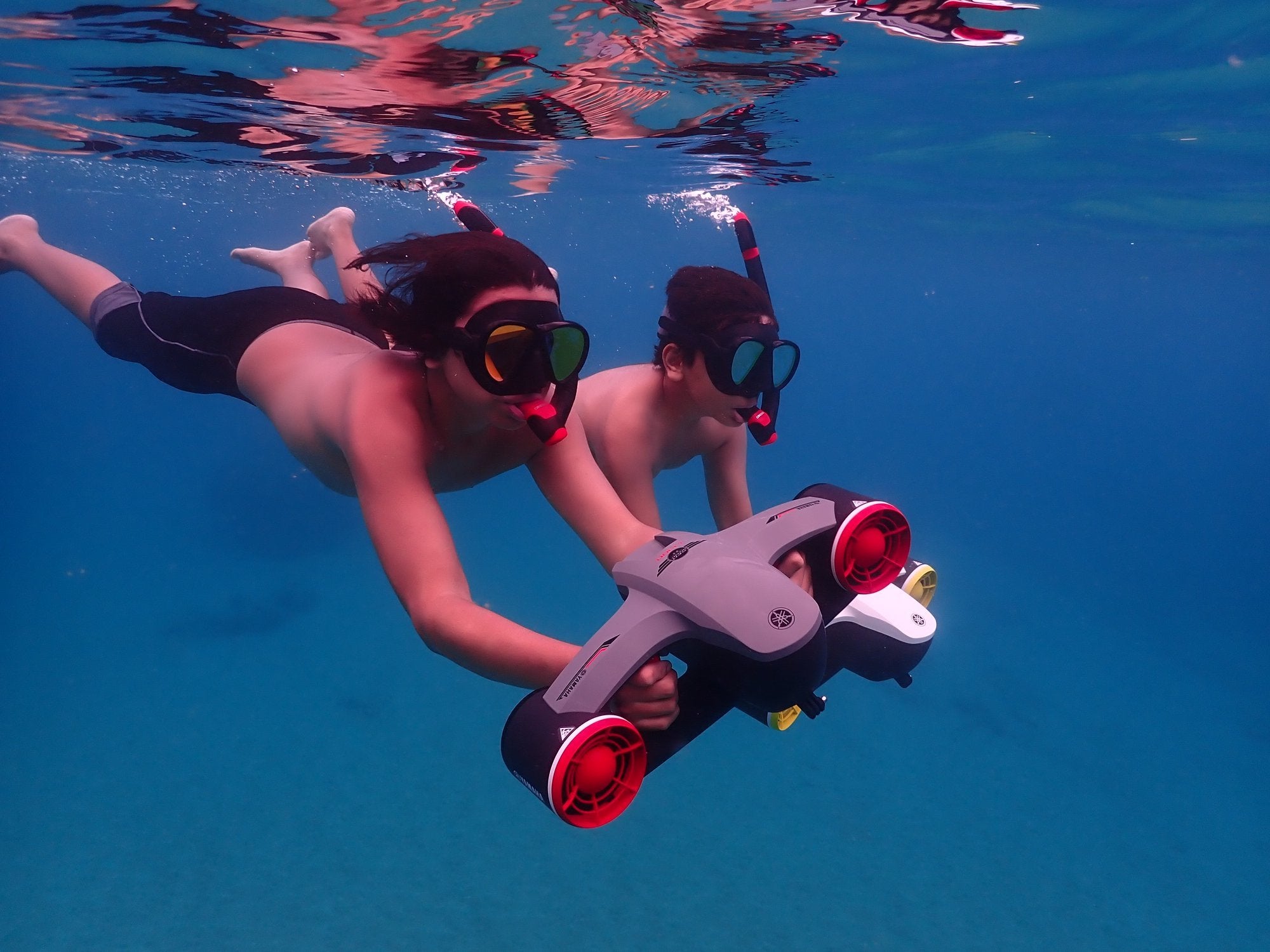 2 young boys use their Yamaha Seawing 2 on their snorkeling adventure. One boy has the red/grey Seawing the other has the yellow/white Seawing 2.