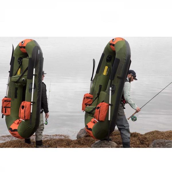 Sea Eagle PackFish7 Inflatable Fishing Boat being carried next to the lake after a successful day fishing. 