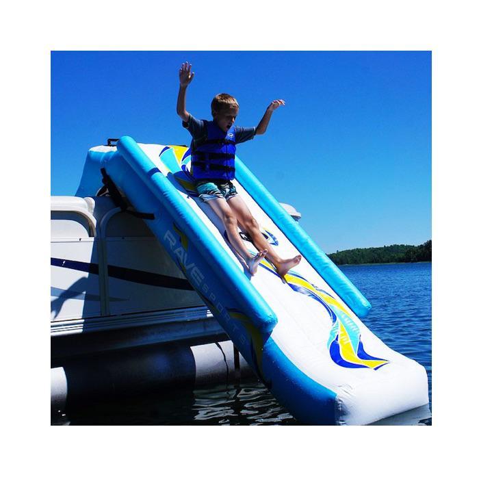 Rave Pontoon Boat Slide in place on the side of a pontoon, white background. The inflatable pontoon slide is white with yellow and light blue highlights.  The Rave 12v high pressure air pump is also shown.  It is black and gray with the Rave logo.