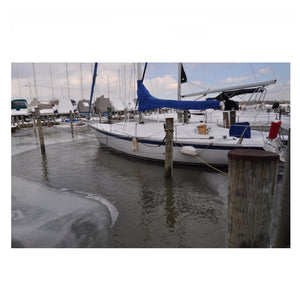 The Bearon Aquatics Powerhouse Ice Eater P750 Ice Eater dock bubbler system melting ice around some wooden docks and pilings.