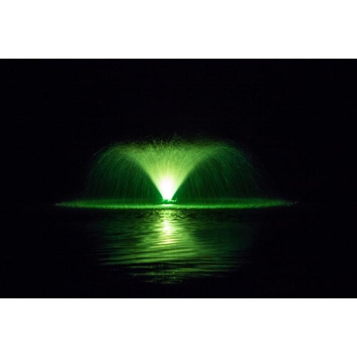 Spray of an aerating fountain is lit up in green with a color changing fountain light kit.