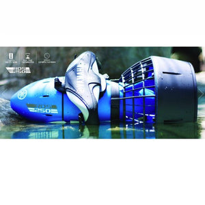 Yamaha RDS 250 Sea Scooter is shown sitting in a pool of water, half submerged.  You can clearly see the details of the black, grey, and mostly blue RDS 250 Sea Scooter. The specs listed on the upper left hand corner show that it reaches a depth of 100ft, has a run time of 120 minutes, and will reach speeds of 2.8 mph.