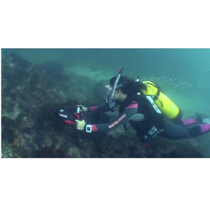 Woman using a Yamaha RDS 300 Seascooter to propel her across the ocean floor exploring a reef.
