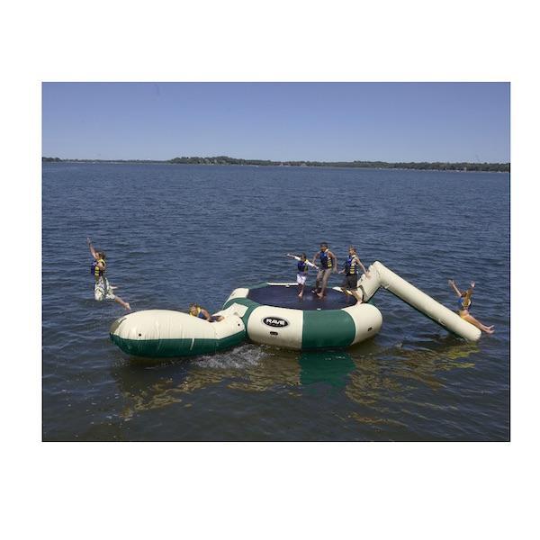 Kid flying off the yellow Aqua Launch on the tan and green Rave Bongo 15 Water Bouncer Water Park which also features a tan Aqua Slide.  The Rave Bongo Water Park is on a calm lake.