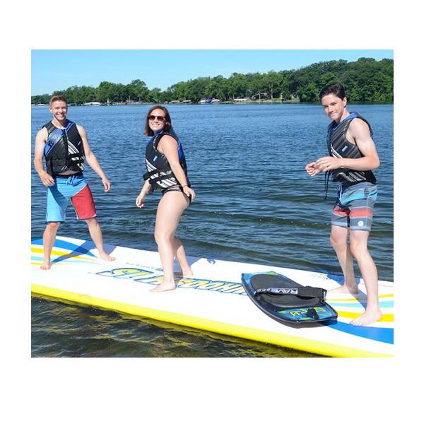 3 people standing and playing on a Rave Water Whoosh Floating Water Mat on the lake.