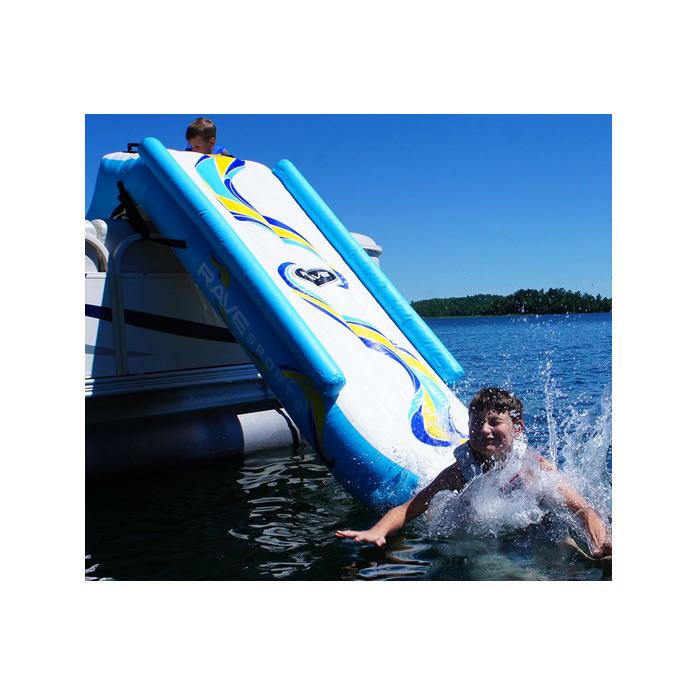 A boy splashes into the lake after a slide down the rave inflatable pontoon boat slide.