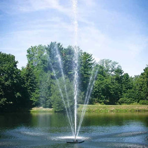 Scott Aerator Clover Pond Fountain 1 1/2 Hp sprays a 40ft water display for all to see.  The floating pond fountain is in the middle of the pond against a beautiful green tree background.