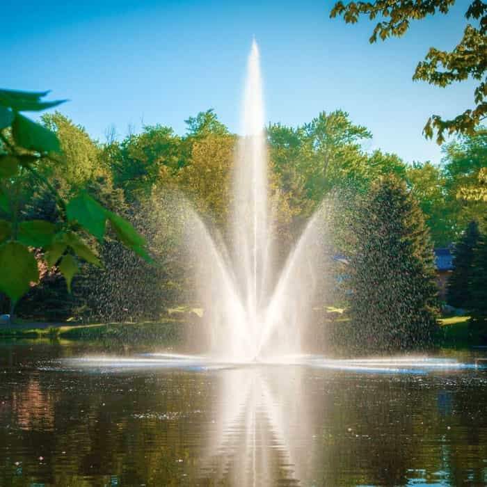 Scott Aerator Atriarch Pond Fountain beautifully sprays water into the air against a background of trees.  The Scott Aerator floating pond fountain, that can also be a lake fountain, sit in the middle of the pond. This beautiful floating water fountain is a glorious sight.