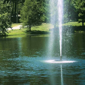 Close up view of the Scott Aerator Gusher Floating Pond Fountain 1 1/2 Hp floating water fountain.  Magnificent spray falling back into the dark blue/green pond.