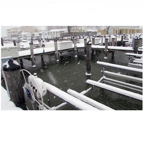 Scott Aerator Slinger Dock De-Icer melted the ice in this marina.  Shows the ice melted around the wooden docks.  Ice is visible in other areas where the slinger dock de icer is not in use.  The dock bubbler system has all of the area clear of ice.