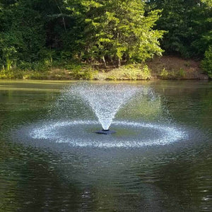 Scott Aerator DA-20 Display Aerator 1/3 Hp Floating Pond Fountain is shown as a floating pond aerator in the middle of a lake.  Green and brown brush and tree background. Also known as a Small Pond Aerator Fountain.