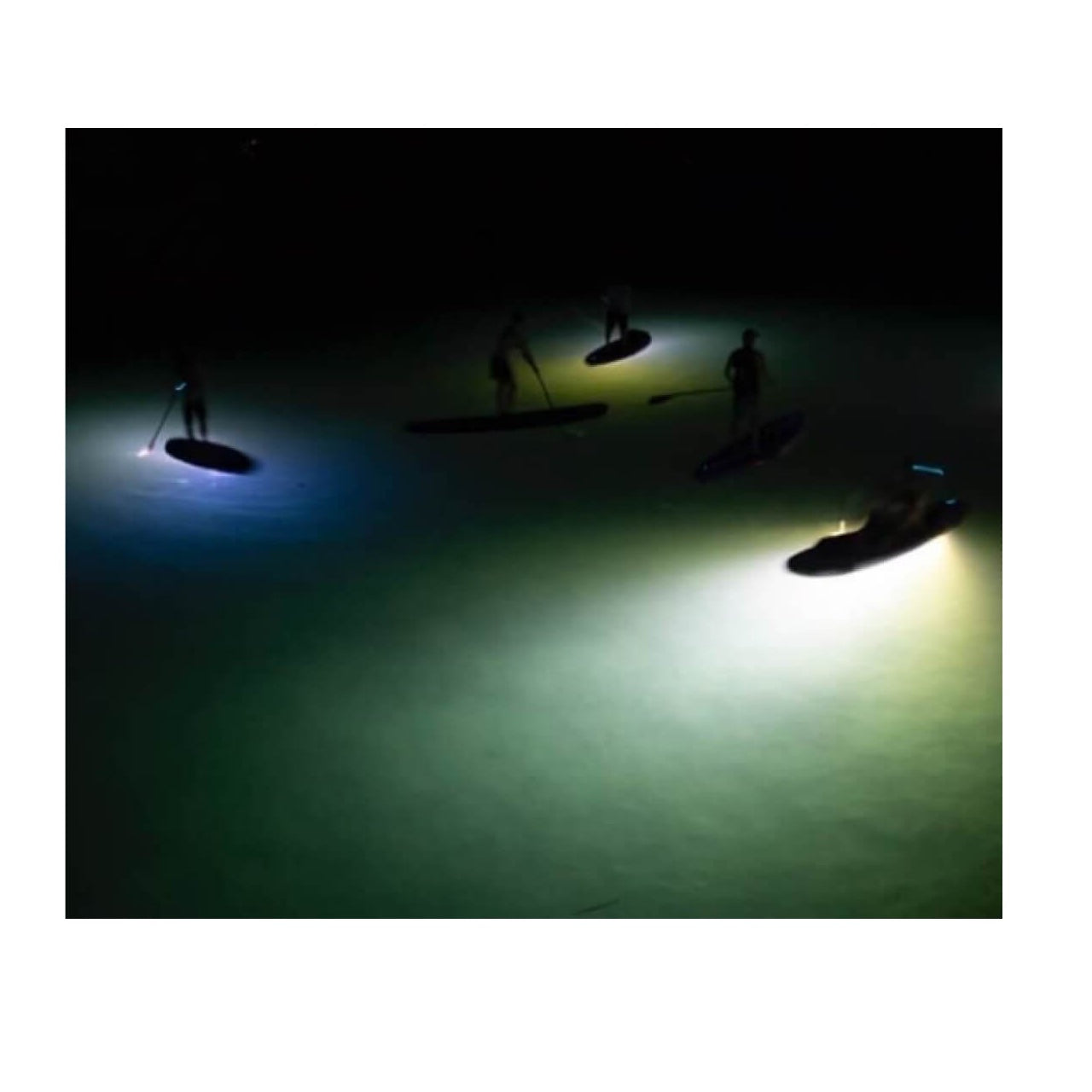 Paddle boarders use the ScubaJet Pro as a paddleboard motor with the BEAM kit. The area below their boards is lit up by the powerful light.