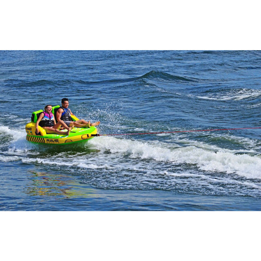 Green and yellow Rave #Stoked 2 Person Towable Boat Tube skipping across the lake. 