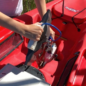 Bixpy Jet Kayak Motor for sale is shown being installed on a kayak using the Bixpy Hobie Mirage Pedal Adapter in the center of a red kayak.  A blue cable is attached and the Outboard Kayak Motor Power Pack is located on the rear of the kayak on a black surface.