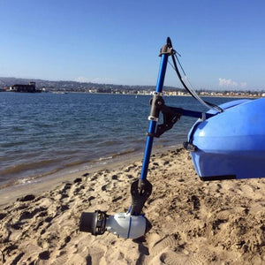 Universal Kayak and Canoe Adapter attached to a blue kayak on the beach