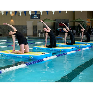 This is an image of 4 Rave Aqua Power Fitness Mats on the pool. There is a woman on each water mat doing the same yoga position.