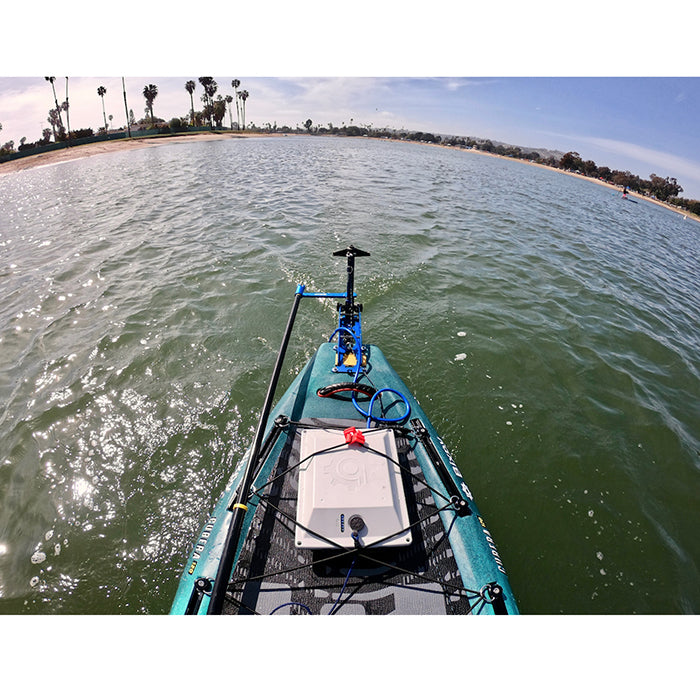 Bixpy Universal Power Pole Kayak Adapter is shown unhinged in the water while the kayak is running. Only the back portion of the kayak is visible.